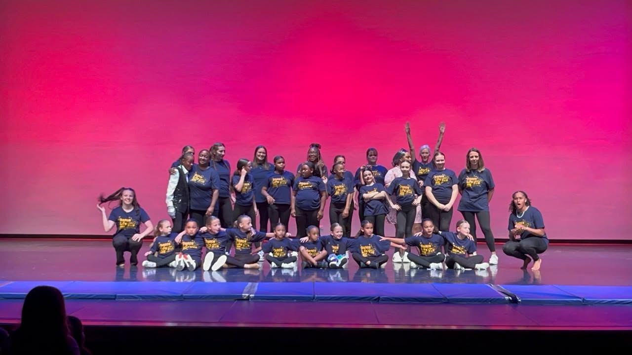 Kids leaping in the air together in a bright ABK dance studio